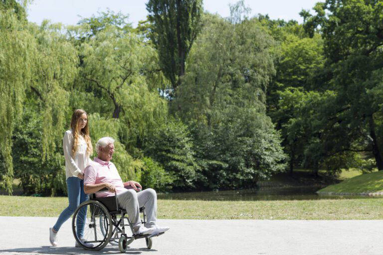 Younger woman with an older man in a wheelchair
