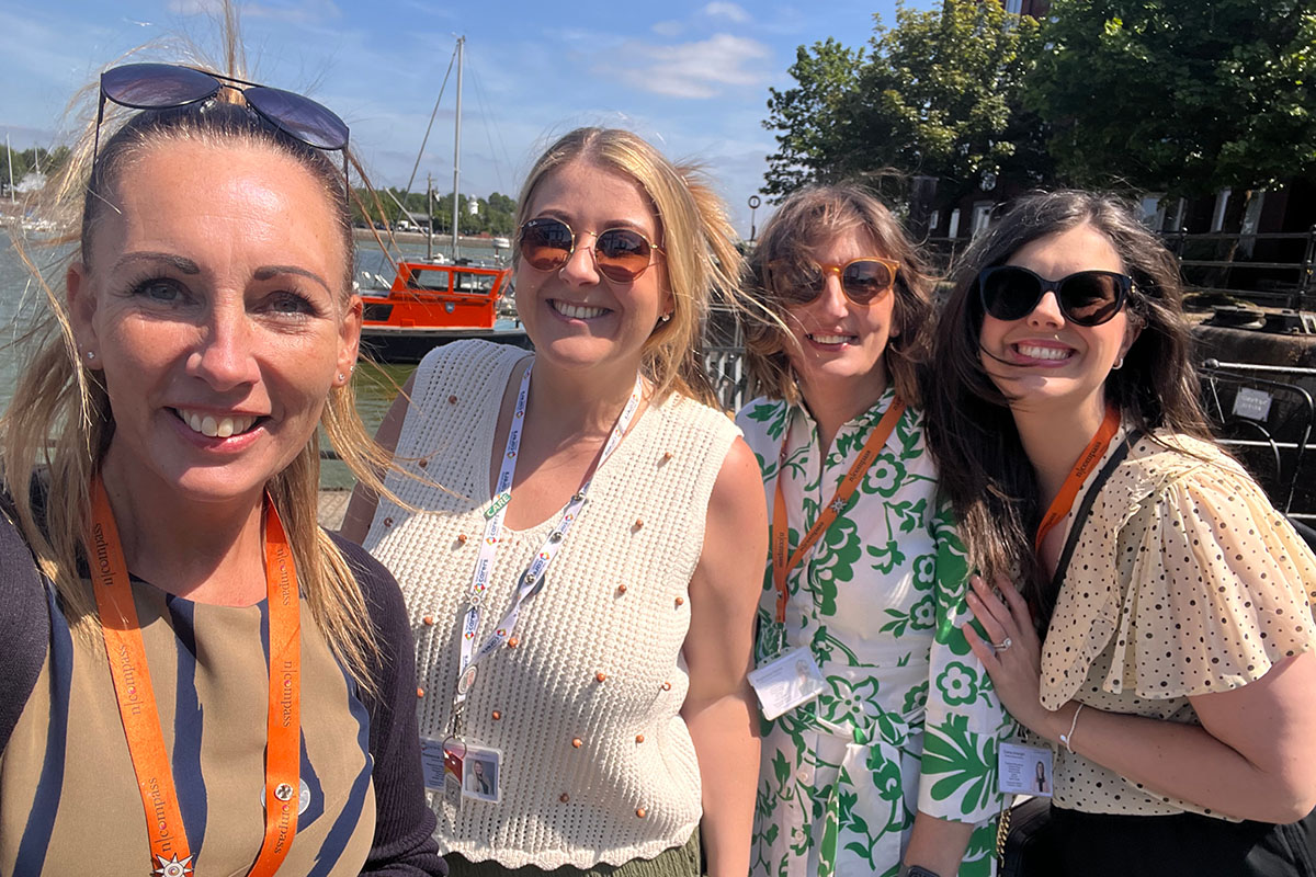 Group of woman at a harbour smiling
